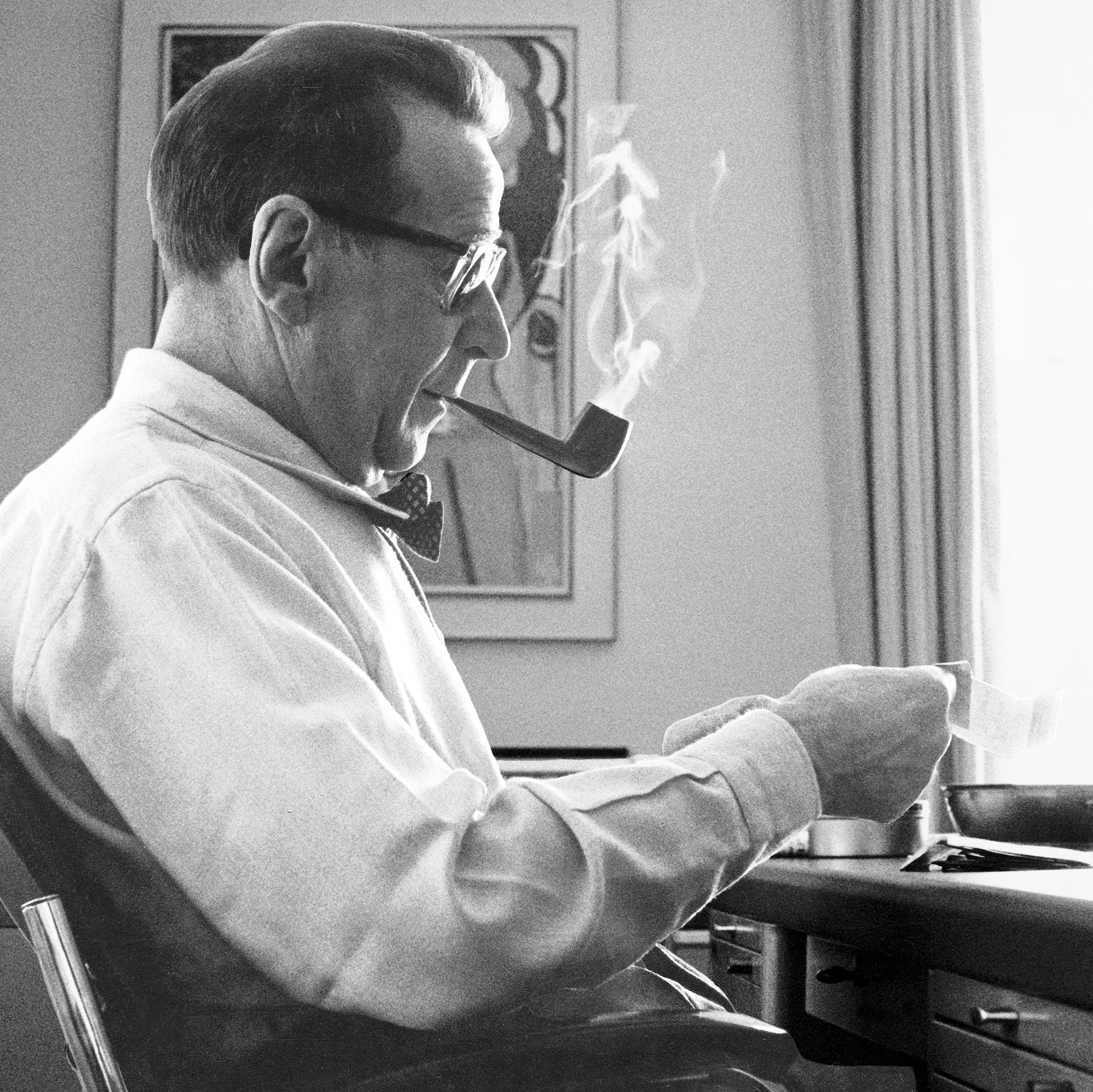 Georges Simenon smoking a pipe